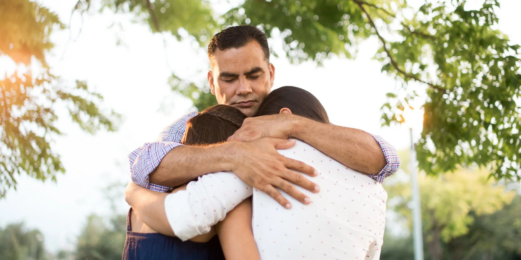 A family embracing outdoors